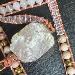 Pink and gold wrap bracelet with pink stone.